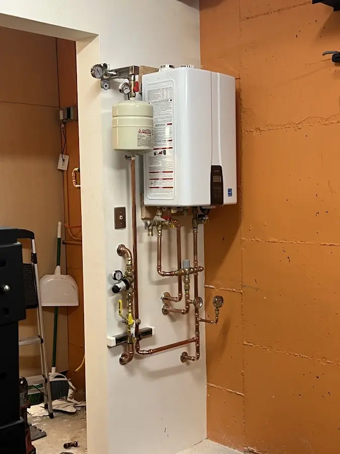 Plumbing technician inspecting water heater connections in Chattanooga